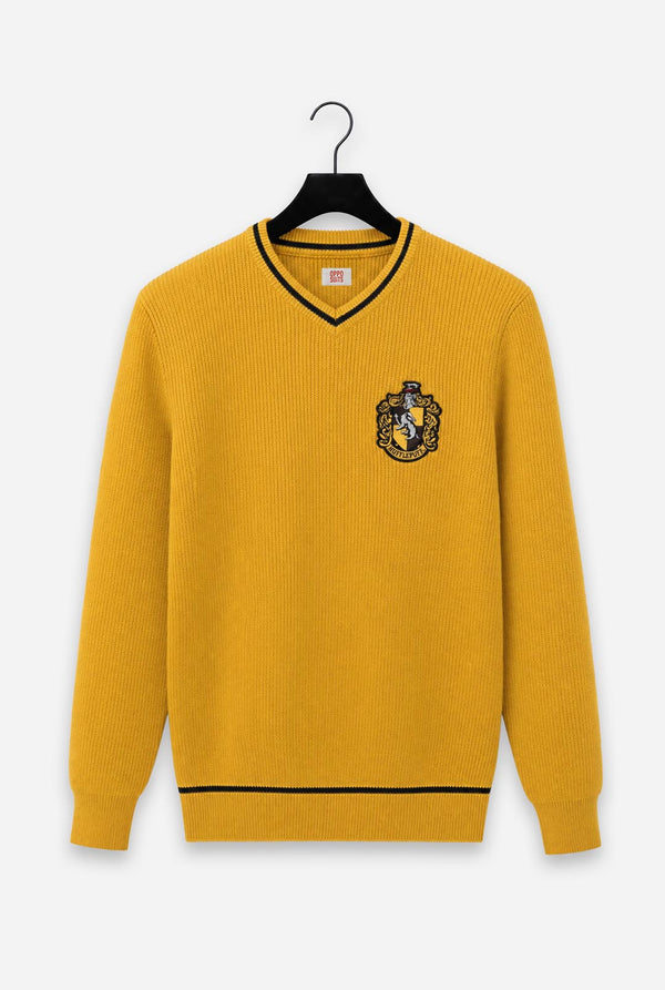 A yellow ribbed knit Harry Potter Hufflepuff sweater with black trim on a black hanger, featuring a embroidered Hufflepuf crest on the left chest.