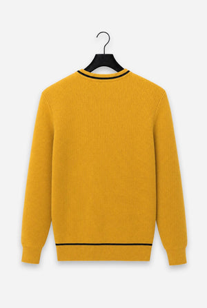 A mustard yellow ribbed knit sweater with black trim at the crew neck and hem, hanging on a black hanger against a light gray background.
