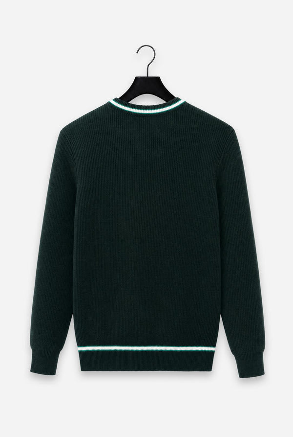 A dark forest green ribbed knit sweater with contrasting light green and white trim at the crew neck and hem, hanging on a black hanger against a light gray background.