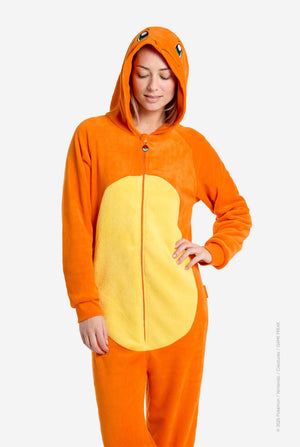 Woman wearing an orange and yellow Pokémon Charmander onesie with a hood on a white background