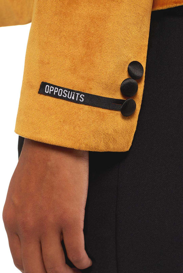 Woman wearing golden velvet dinner jacket blazer, sleeve close up