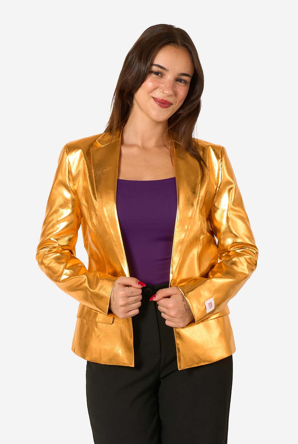 Woman wearing a shiny gold jacket over a purple top on a white background