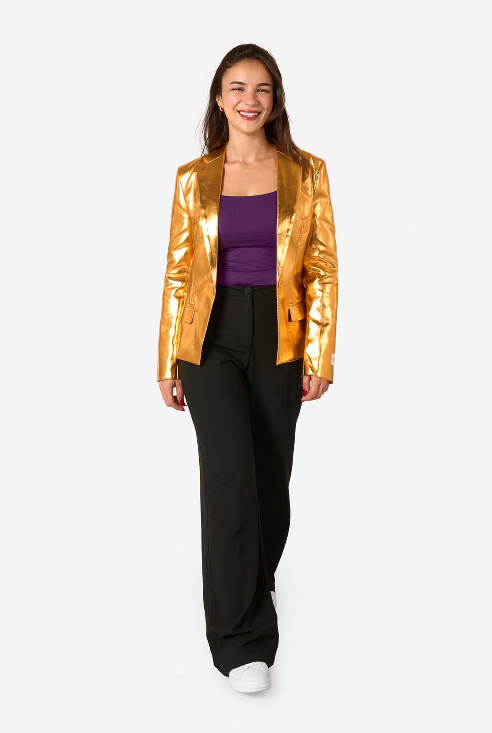 Woman wearing a shiny gold jacket over a purple top on a white background