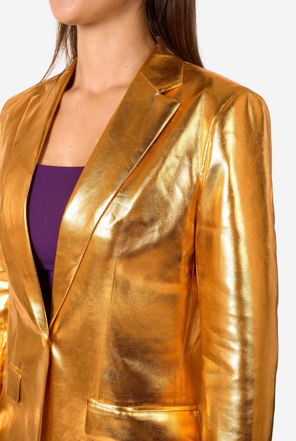 Gold metallic blazer worn by a woman on a white background, chest close up.