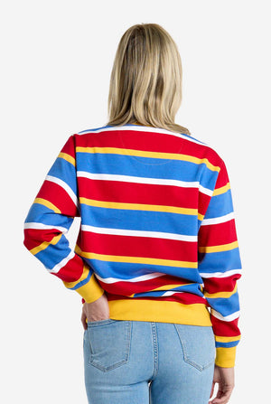 Person wearing a colorful striped sweater with a plain background