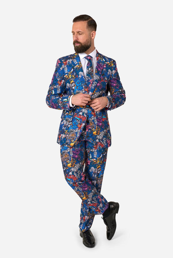 Man wearing a colorful suit with Transformer pattern on a light background. Full body image.