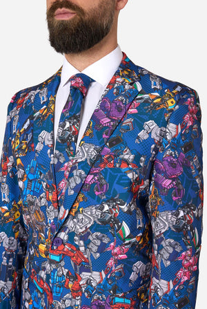 Man wearing a colorful suit with Transformer pattern on a light background. Chest close-up.
