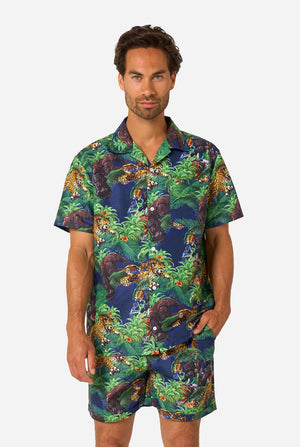 Man wearing a colorful tropical Transformers animal print summer set on a light background.