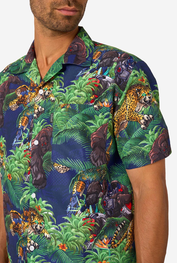 Man wearing a colorful tropical Transformers animal print summer set on a light background. Chest close-up.
