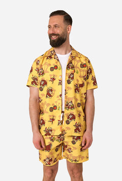 Man wearing a yellow Donkey Kong patterned shirt and shorts on a white background