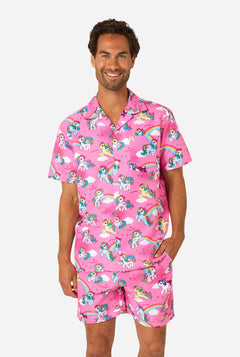 Man wearing pink My Little Pony pajama set with unicorn and rainbow pattern on a white background