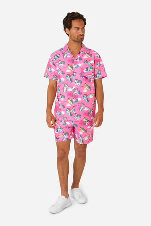 Man wearing pink summer set with My Little Pony and rainbow pattern on a light background. Full body image.