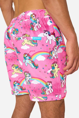 Man wearing pink summer set with My Little Pony and rainbow pattern on a light background. Shorts close-up.