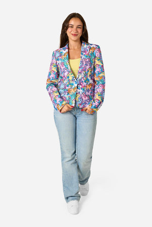 Woman wearing a colorful patterned My Little Pony blazer on a light background.  Full body image.