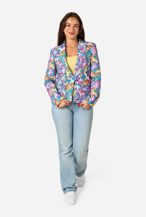 Woman wearing a colorful patterned My Little Pony blazer on a light background.  Full body image.