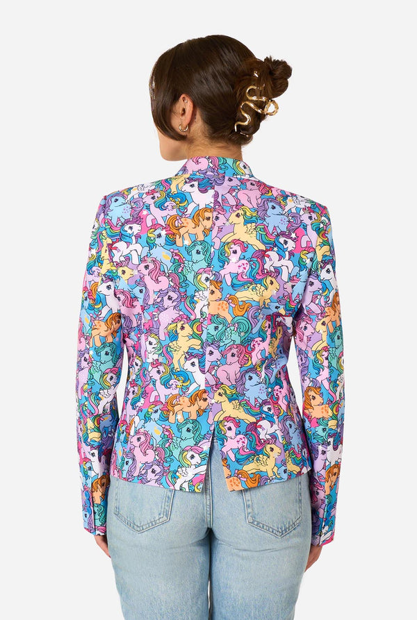 Woman wearing a colorful patterned My Little Pony blazer on a light background. View from the back.