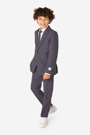 Kid wearing a stylish charcoal colored grey suit with a white dress shirt, smiling confidently. Perfect formal outfit for boys' special occasions, weddings, and parties. Full body image.