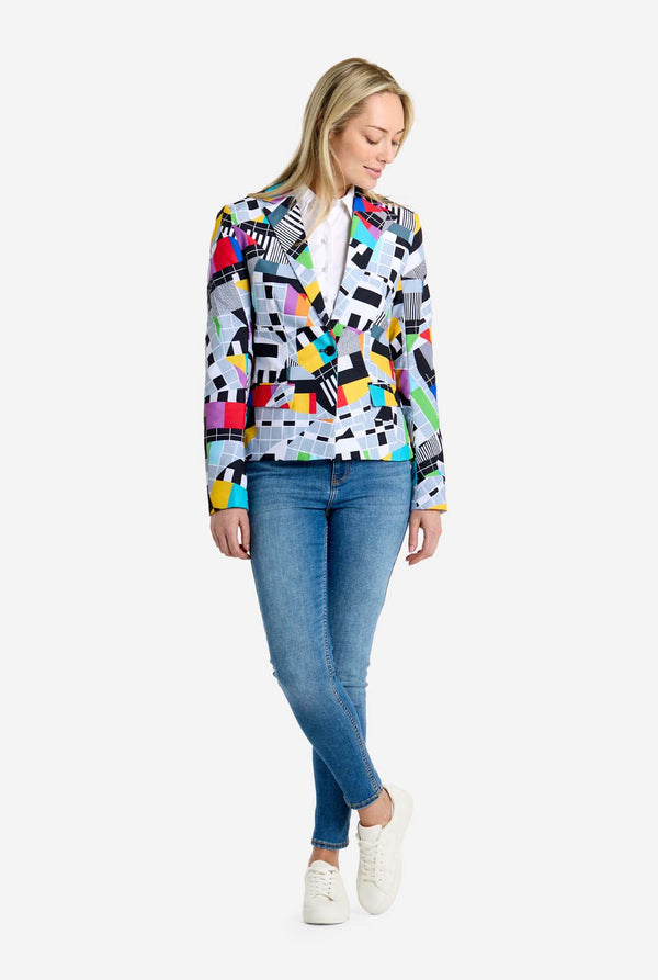 Woman wearing a colorful geometric-patterned jacket on a white background