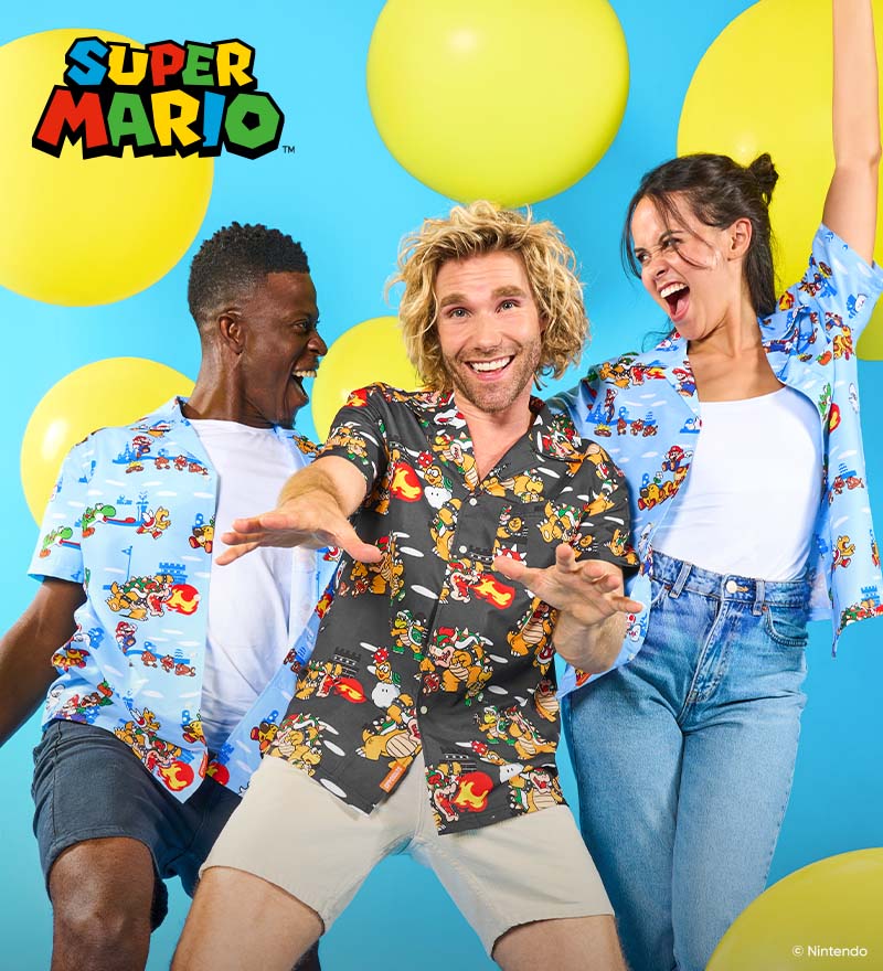 Three people wearing colorful Super Mario print shirts pose enthusiastically in front of a bright blue background with large yellow balloons. The Super Mario logo appears in the top left corner.