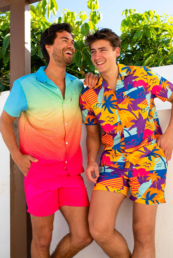 Image of two men standing in garden wearing colorful OppoSuits Summer Sets.