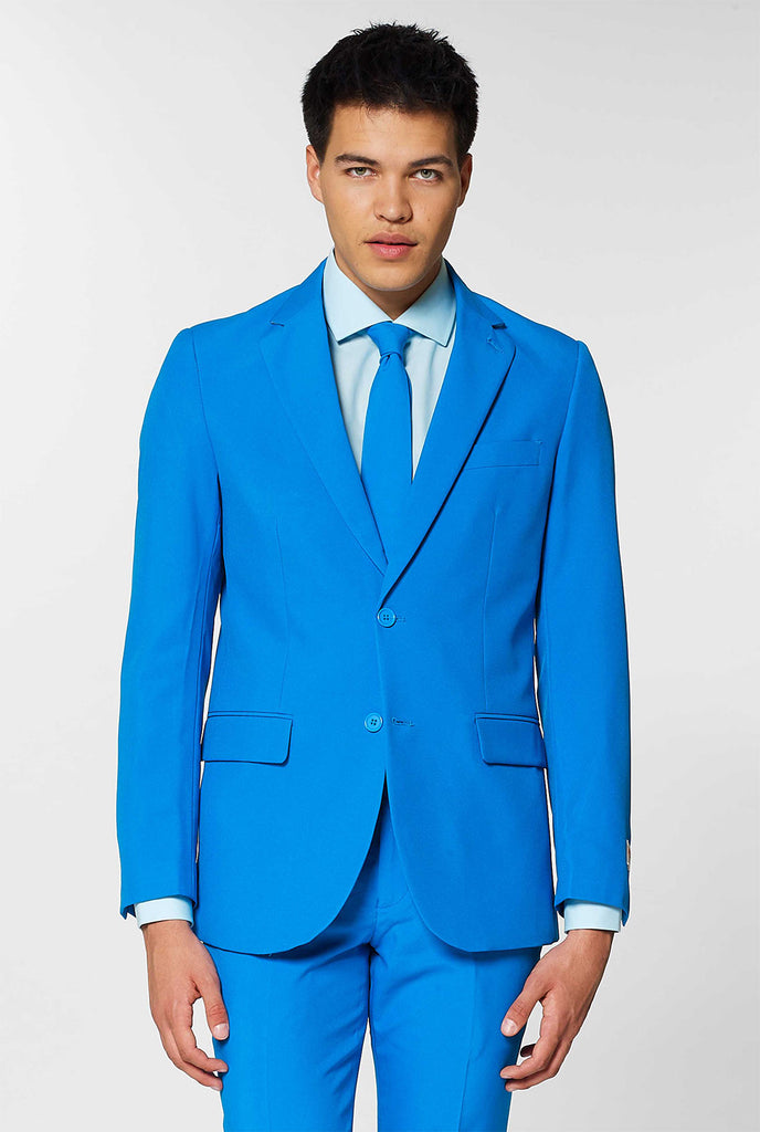 Video of man wearing Blue Steel blue men's suit, showing suit like a model. Suit consists of blazer, pant and tie.