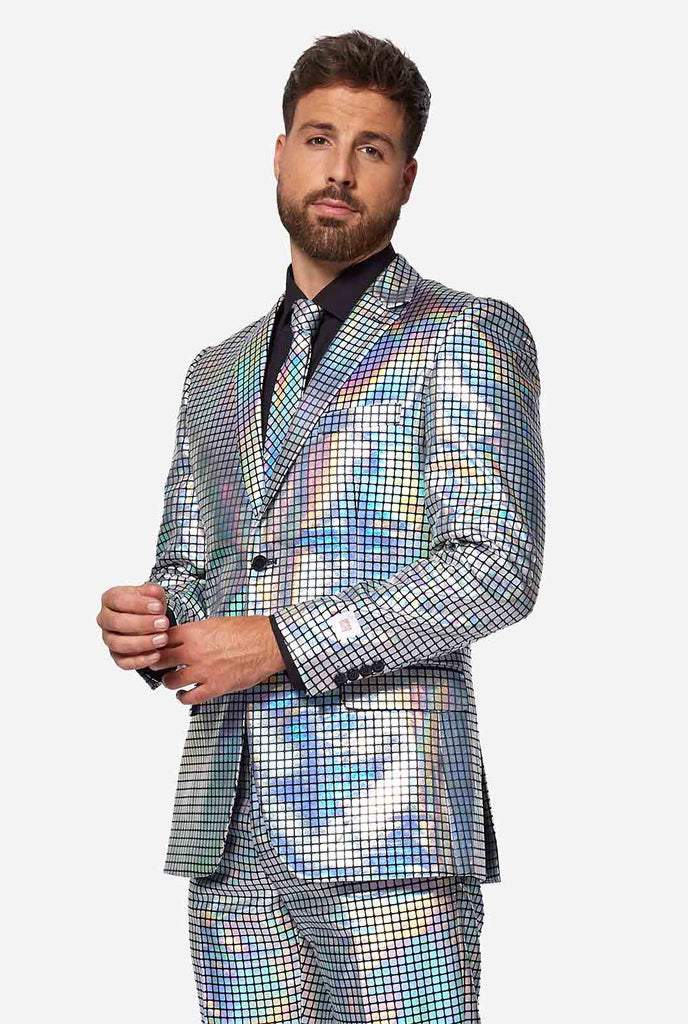 Video of man wearing Discoballer men's suit with mirror discobal print, showing suit like a model. Suit consists of blazer, pant and tie.