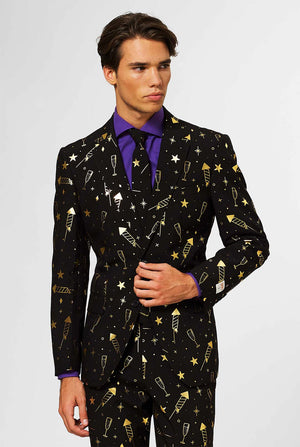 Video of man wearing Fancy Fireworks men's suit with golden foil firework print, showing suit like a model. Suit consists of blazer, pant and tie.