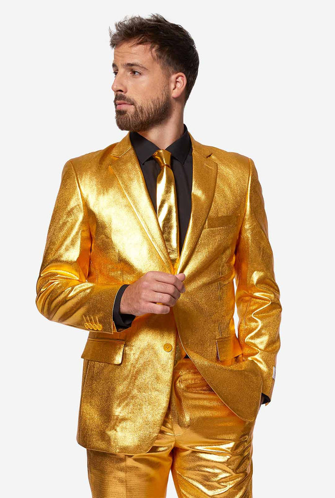 Video of man wearing Groovy Gold, golden men's suit, showing suit like a model. Suit consists of blazer, pant and tie.