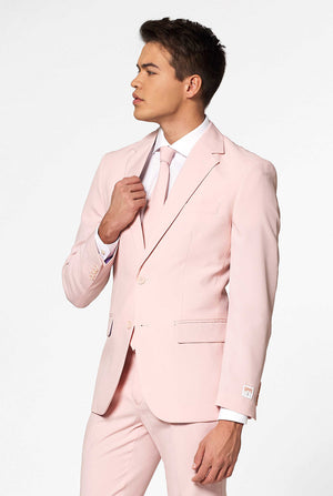 Video of man wearing Lush Bush, soft pink men's suit, showing suit like a model. Suit consists of blazer, pant and tie.