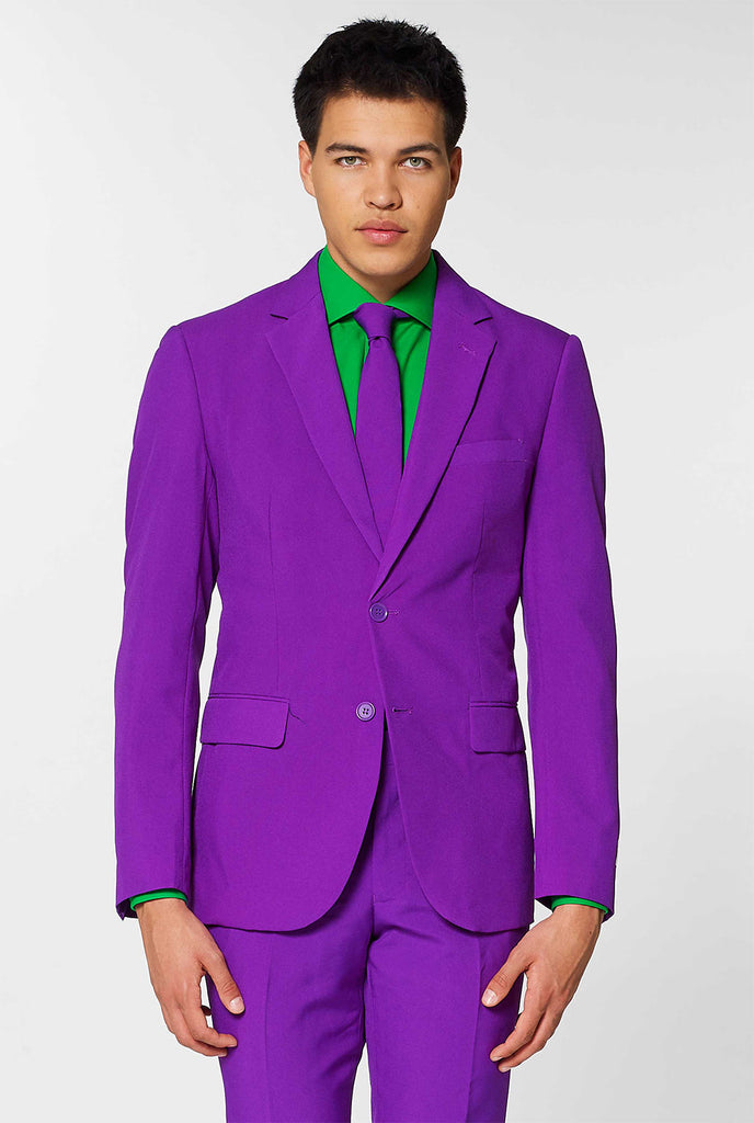 Video of man wearing Purple Prince, purple men's suit, showing suit like a model. Suit consists of blazer, pant and tie.