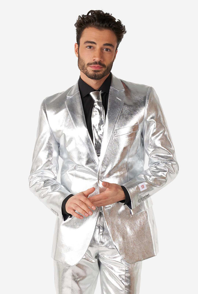 Video of man wearing Shiny Silver, silver men's suit, showing suit like a model. Suit consists of blazer, pant and tie.