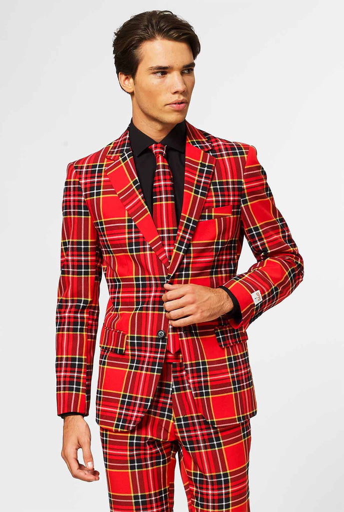 Video of man wearing The Lumberjack red tartan men's suit, showing suit like a model. Suit consists of blazer, pant and tie.