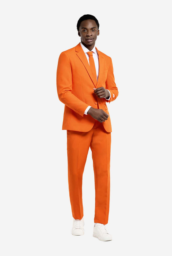 Video of man wearing The Orange, orange men's suit, showing suit like a model. Suit consists of blazer, pant and tie.