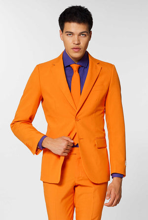 Video of man wearing The Orange, orange men's suit, showing suit like a model. Suit consists of blazer, pant and tie.