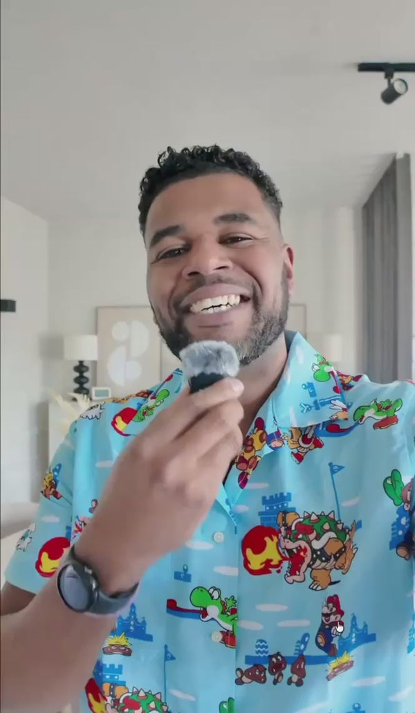 Man filming himself wearing a Super Mario themed shirt from OppoSuits