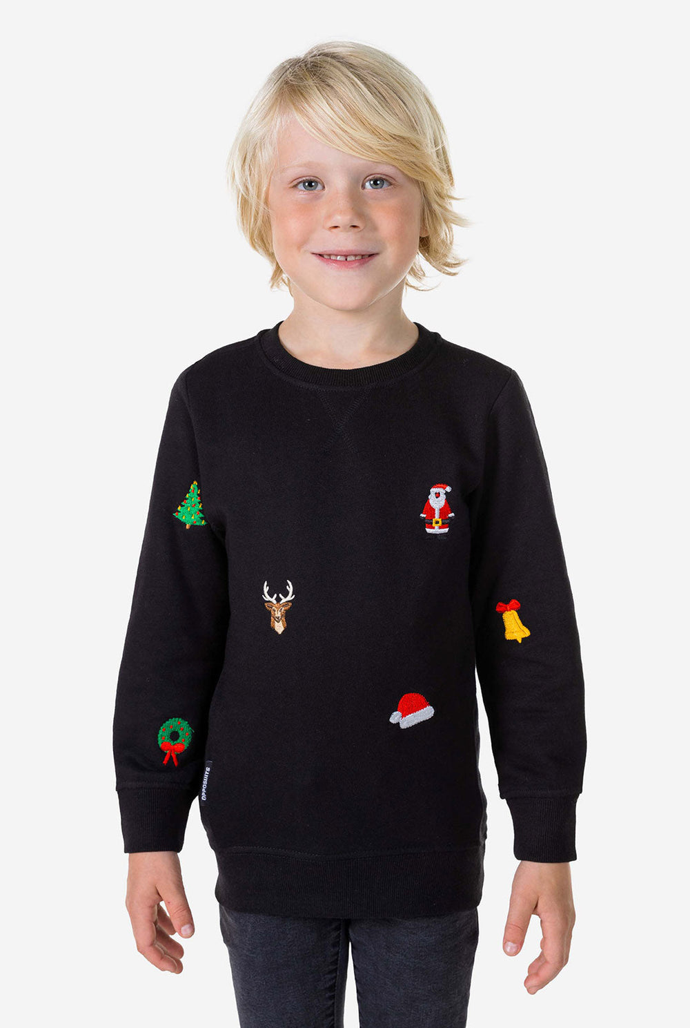 Kid wearing black Christmas sweater with Christmas icons