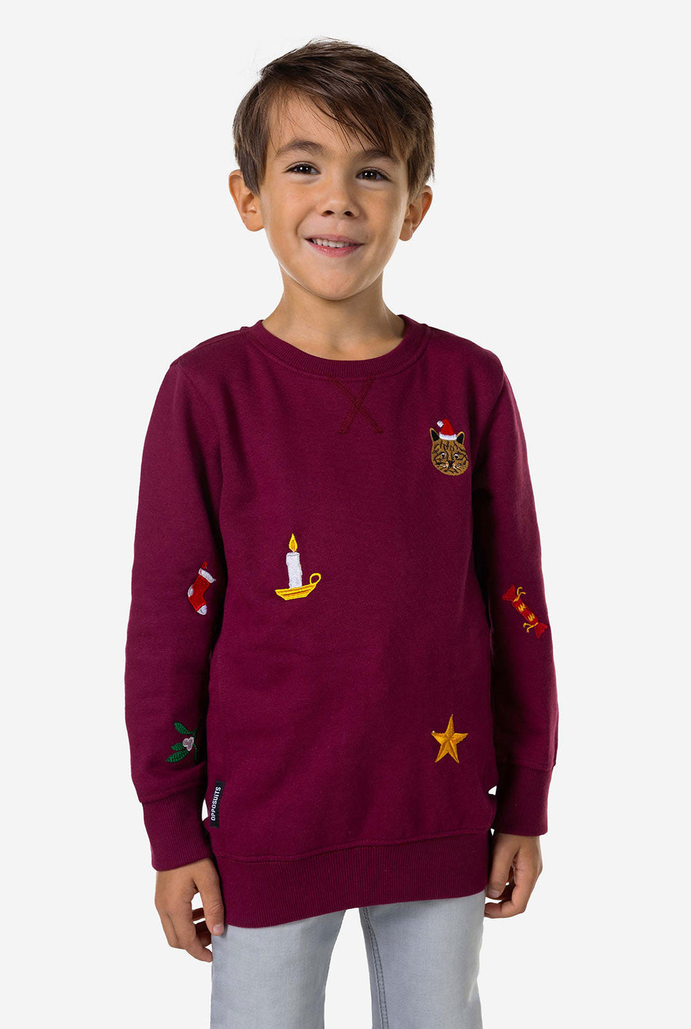 Kid wearing burgundy red Christmas sweater with colored Christmas icons