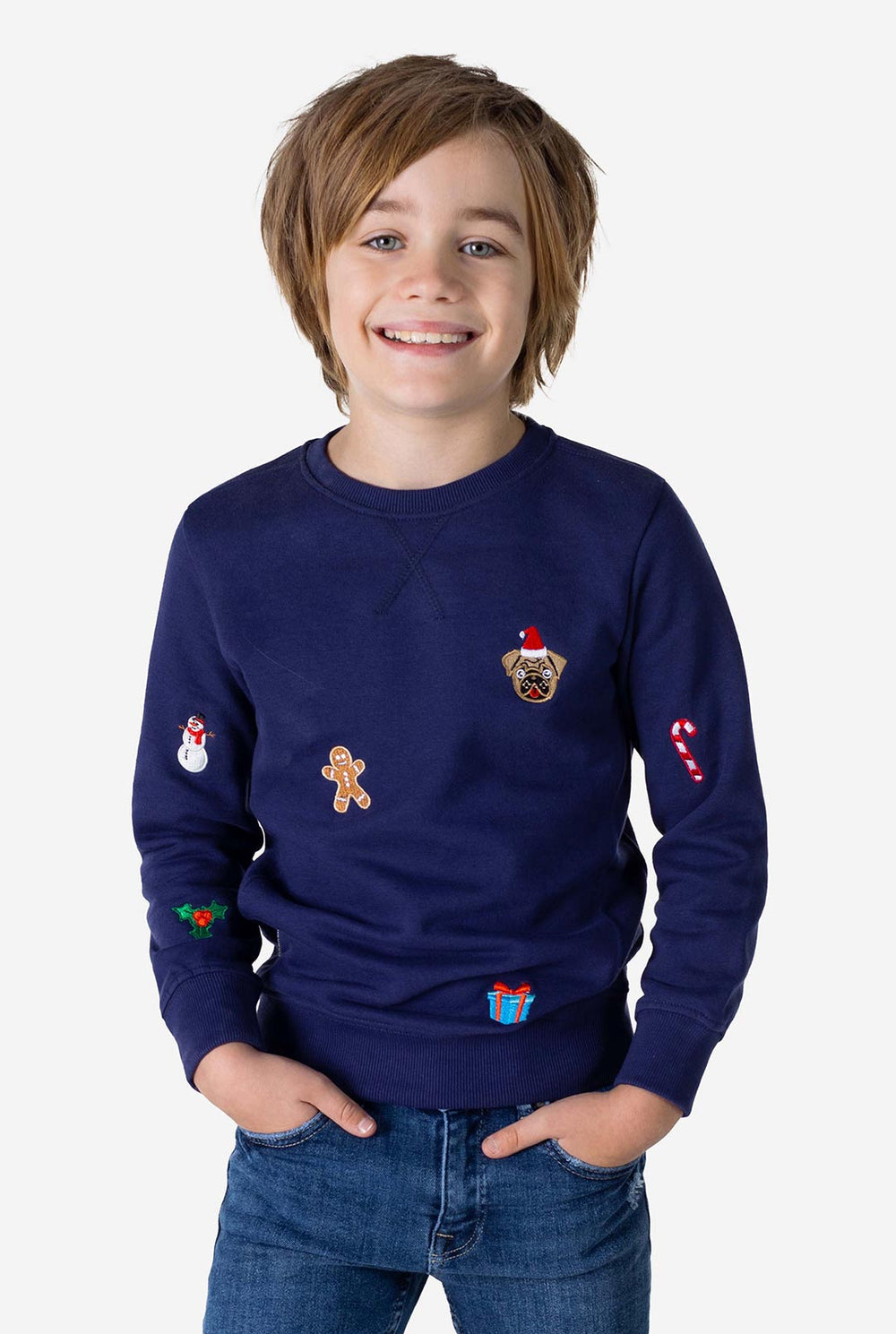 Kid wearing blue Christmas sweater with colored Christmas icons