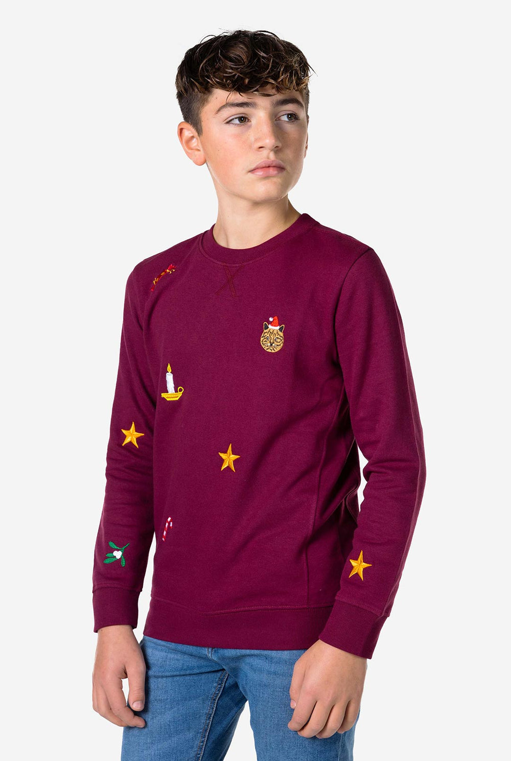 Teen wearing burgundy red Christmas sweater with colored Christmas icons