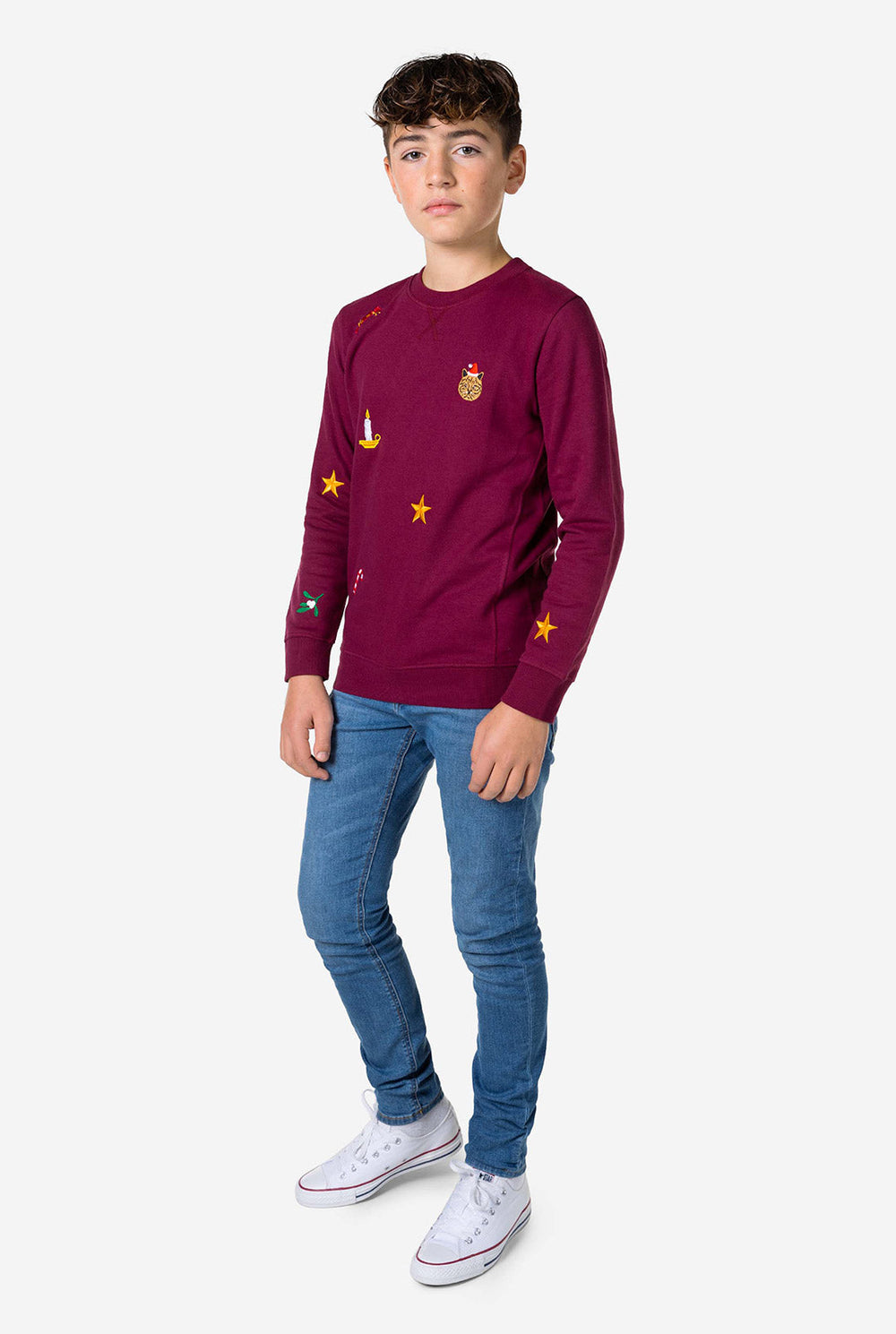 Teen wearing burgundy red Christmas sweater with colored Christmas icons