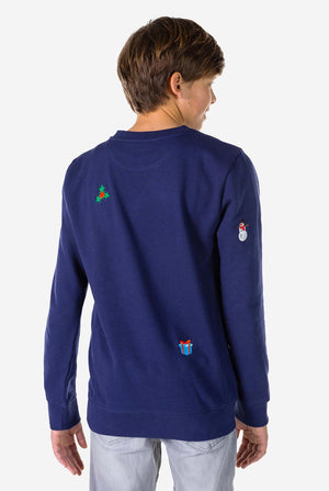 Kid wearing blue Christmas sweater with Christmas icons