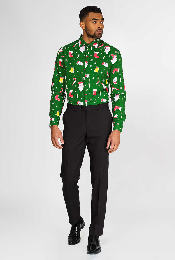 Man wearing green Christmas dress shirt with colored Christmas icons and black dress pants