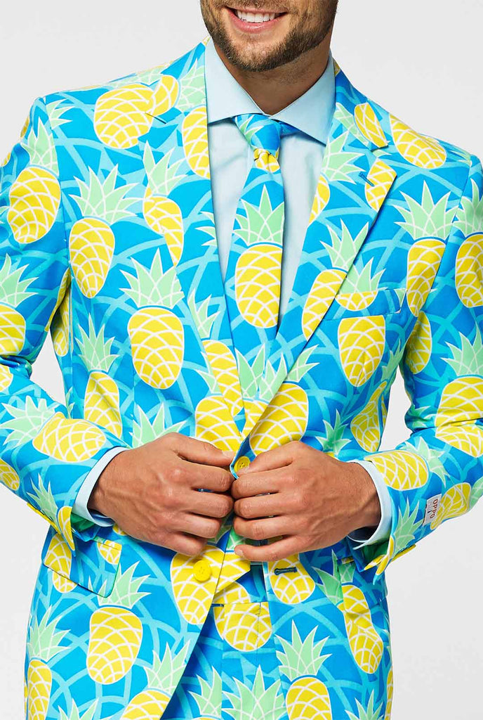 Pineapple print men's suit with bright colors by man close up