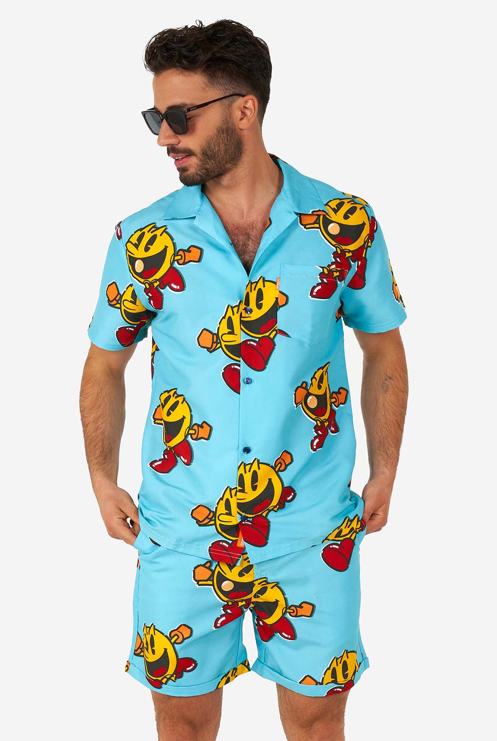 Man wearing blue summer shorts and shirt, with Pac-Man print