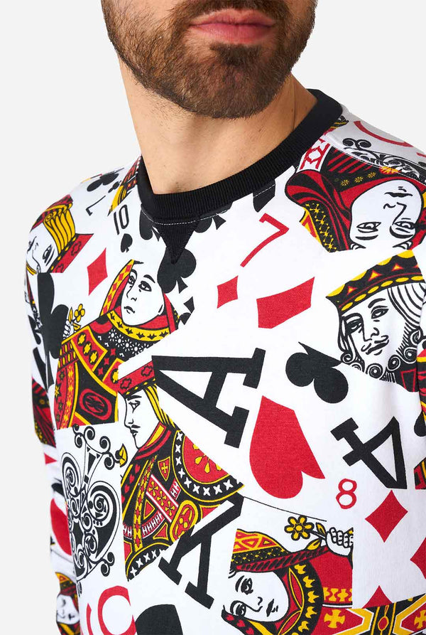Man wearing white sweater with playing cards print