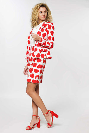 Woman wearing white Valentine's Day suit with red hearts